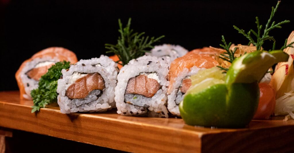 Delicious sushi rolls artfully arranged on a wooden platter, perfect for culinary promotions.