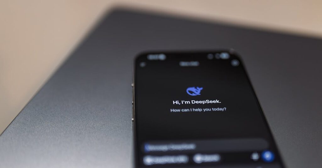 Close-up of a smartphone with AI assistant interface on screen over a laptop.