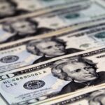 Close-up of crisp US twenty dollar bills arranged in a pattern. Ideal for finance-related visuals.